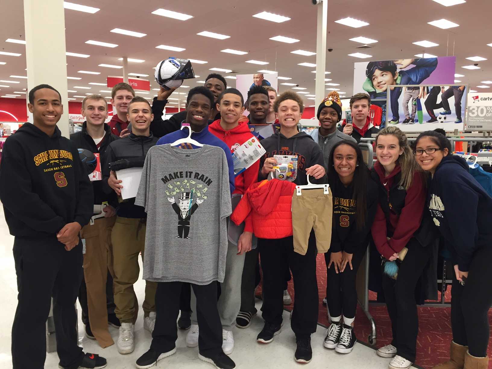 The boys' basketball team shops for their adopted family as part of the SHS Adopt-a-Family. Schaumburg High School students and staff provided gifts for members of 19 families and four senior citizens.