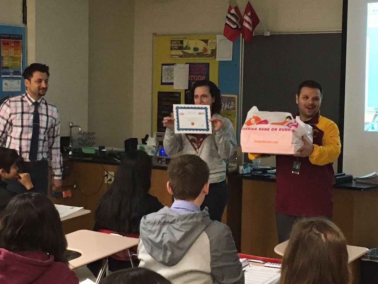 Mr. Matarazzo and Mr. Mehreioskouei award Mrs. Hensley's class for winning the Trudy competition. Classes will continue to compete throughout the remainder of the school year.
