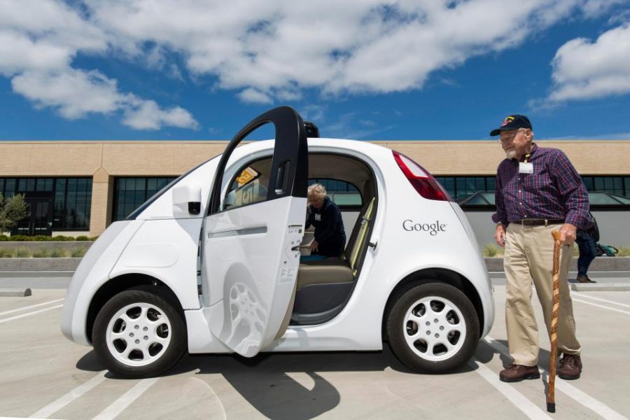 A passenger approaches a self-driving car.