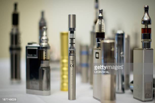A selection of Nicotine Containing Products, or NCPs are displayed during The E-Cigarette Summit at the Royal Academy in central London on November 12, 2013.  The merits of e-cigarettes were thrashed out at a one-day gathering of scientists, experts, policymakers and industry figures at the Royal Society in London. The use of electronic cigarettes -- pen-sized battery-powered devices that simulate smoking by heating and vaporising a liquid solution containing nicotine -- has grown rapidly.  AFP PHOTO / LEON NEAL / AFP PHOTO / LEON NEAL        (Photo credit should read LEON NEAL/AFP via Getty Images)