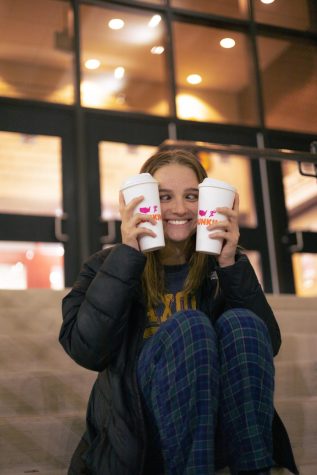 Kalyleigh Maher holds up her two coffees prior to the beginning of the school day. American teenagers consume up to eight times the suggested maximum.