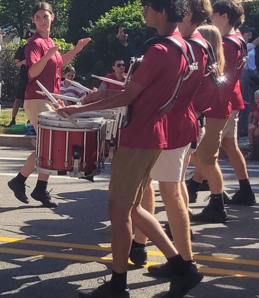 Drum major Leah Robin leads a marching band section. 