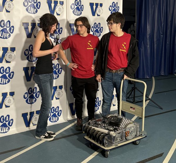 Peyton Caster and Ethan Pikscher discuss the bots design at the Robotic Rumble on March 10.