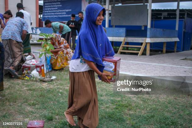 Rohingya refugees are seen carrying rice and gifts at the Vocational Training Center (BLK) Building, in Lhokseumawe, on May 1, 2022, Aceh Province, Indonesia. Volunteers from the Helping Hand for Relief and Development (HHRD) distributed parcels and Zakat al-Fitr to 25 Rohingya refugees who were accommodated in temporary shelters ahead of Eid al-Fitr in Aceh. (Photo by Fachrul Reza/NurPhoto via Getty Images)