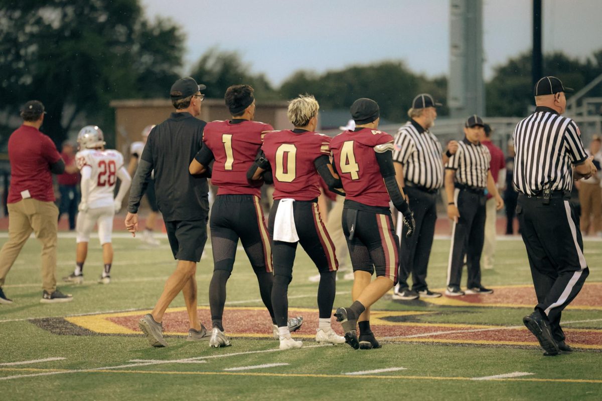 Coach Mark Stilling and captains Ray Black, Kile Gough, and Vince Heydecker take the field against Antioch in a season opening 34-29 loss.
