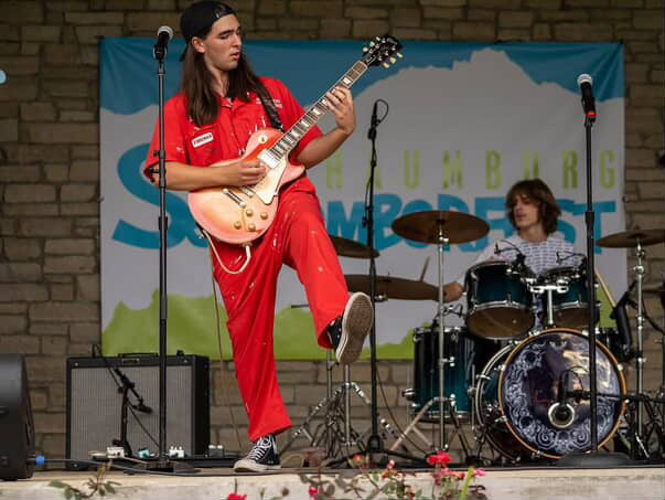 Senior Luke McCoy fronts Schaumburg School of Rock House Band at the annual September Fest