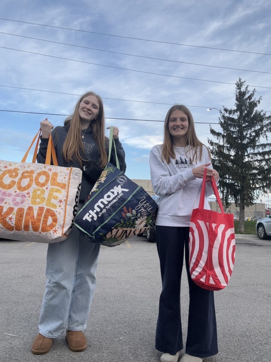 Sophie Mishler and Victoria Zbierajewski deliver sock donations to Journey’s Homeless Shelter. 